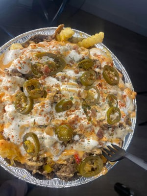 Loaded Jerk Philly Cheesesteak Fries with pop