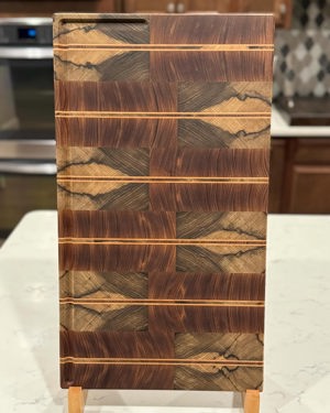 African teak, limba black and maple cutting board