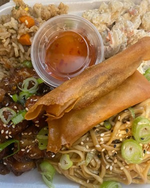 Sesame chicken with sesame noodles, fried rice, mac salad and lumpia