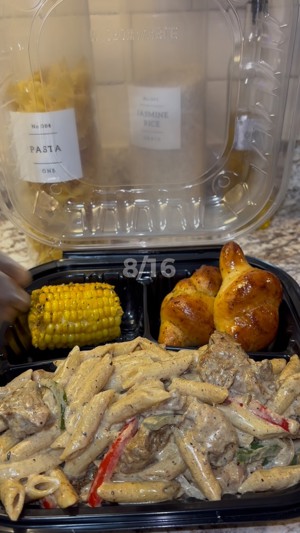 Rasta Pasta plate with blackened chicken, garlic knots and corn on the cob