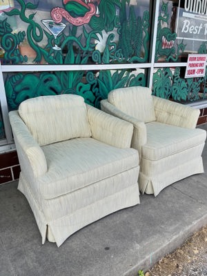 Midcentury upholstered armchairs on casters