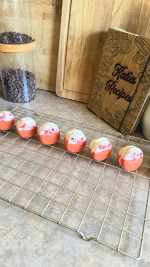 French Macarons with Strawberry Filling dipped in White Chocolate by Katelyn's Konfections